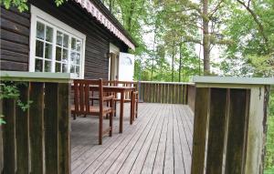 a wooden deck with a bench on a house at Holiday Home Loaklev Vetlanda Ii in Loaklev