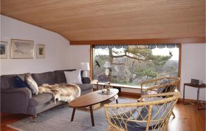 a living room with a couch and a table at Awesome Home In Haverdal With Wifi in Haverdal