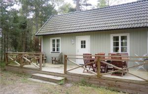 a house with chairs and a deck in front of it at Stunning Home In Lttorp With 3 Bedrooms And Wifi in Böda