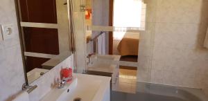 a white bathroom with a sink and a mirror at Quinta Nova Vale Del Rey in Carvoeiro