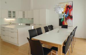 a kitchen with a dining room table and chairs at Nice Home In Farsund With 4 Bedrooms in Farsund