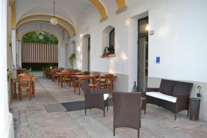 a restaurant with wooden tables and chairs in a building at Hotel Riviera Ristorante La Briciola in San Bernardino