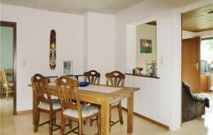 a kitchen and dining room with a wooden table and chairs at Stunning Apartment In Duppach With Kitchen in Duppach