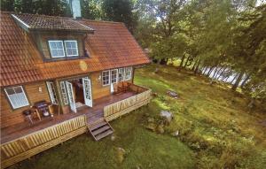 an aerial view of a wooden house with a porch at Lovely Home In Kvicksund With Sauna in Kvicksund