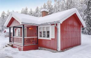 a red house with snow on the roof at Amazing Home In Sysslebck With Kitchen in Sysslebäck