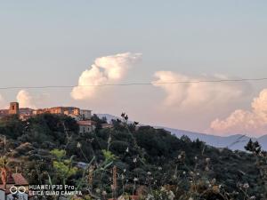 a town on top of a hill with clouds at Casa Vacanze - B&B Il Tempone in Prignano Cilento