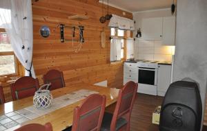 a kitchen with a table and chairs in a room at 3 Bedroom Lovely Home In Bstad in Unnstad