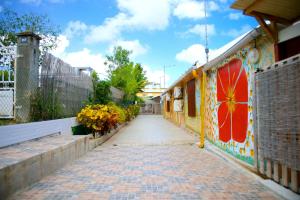 a brick road with flowers on the side of a building at Holiday Home Soleil de Gwada in Sainte-Anne
