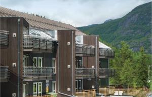 a row of buildings with balconies with mountains in the background at 2 Bedroom Awesome Apartment In Hemsedal in Hemsedal