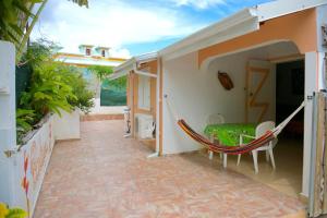 a hammock in the courtyard of a house at Holiday Home Soleil de Gwada in Sainte-Anne