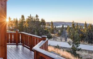 a wooden deck with a view of a road at Two-Bedroom Holiday Home In Sjusjoen in Sjusjøen