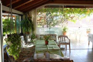 a patio with a table and chairs and plants at Rose Pension in Dalyan