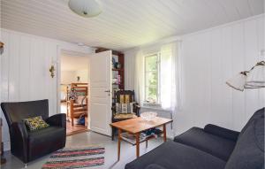 a living room with a couch and a table at 2 Bedroom Stunning Home In Strmstad in Lommeland