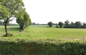 a field with two trees in the middle of it at 1 Bedroom Cozy Apartment In Sainteny in Sainteny