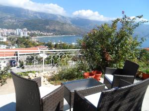 a balcony with chairs and a view of the water at Guest House Budva in Budva