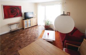 a living room with a couch and a tv at Lovely Apartment In Bad Pyrmont in Bad Pyrmont