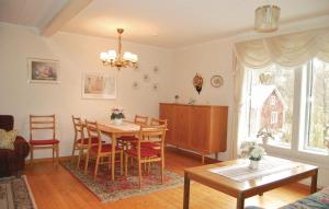 a living room with a dining room table and chairs at Holiday Home Barkhult Ullared in Källsjö