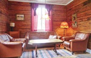 a living room with leather chairs and a coffee table at Holiday Home Hagen Barnebo Blomstermåla in Barnebo