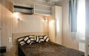 a bedroom with a bed with pillows on it at Nice Home In Grandcamp Maisy With Wifi in Grandcamp-Maisy +14 photos