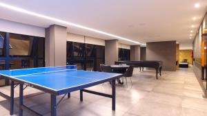 Habitación con mesa de ping pong y pelotas de ping pong. en Apartamento de alto luxo. en Maceió
