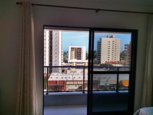 Cette chambre dispose d'une fenêtre offrant une vue sur la ville. dans l'établissement Apartamento de alto luxo., à Maceió