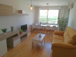 a living room with a couch and a table at Ático BELLAVISTA con visita a bodega y cata de vinos 4 habitaciones dobles 2 baños completos in Tudela