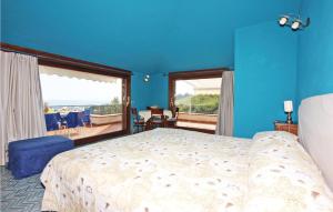 a bedroom with a bed and a blue wall at Villa Sole in Bosco