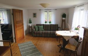 a living room with a couch and a table at Two-Bedroom Holiday Home Skeppshult 02 in Skeppshult