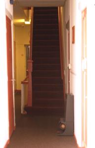 a hallway with stairs in a house with a television at CoronaZeist-Utrecht NL in Zeist