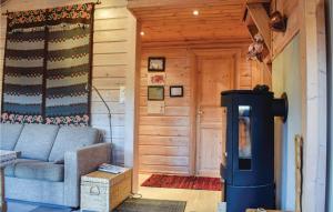 a living room with a blue couch and a fireplace at Three-Bedroom Holiday Home In Aseral in Åseral