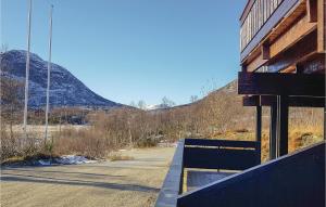 a building on a street with a mountain in the background at Beautiful Apartment In Hovden With House A Mountain View in Hovden