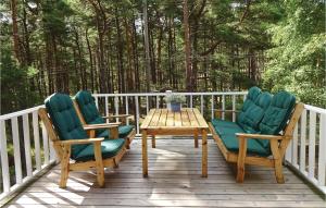 two chairs and a table on a wooden deck at Nice Home In Yngsjö With Wifi in Yngsjö