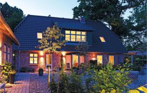 a brick house with a lot of windows at Cozy Home In Gammelby With Sauna in Gammelby