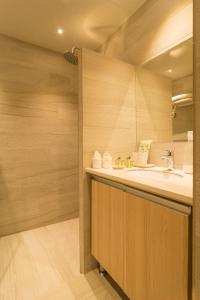 a bathroom with a sink and a mirror at Cuna Hotel in El Nido