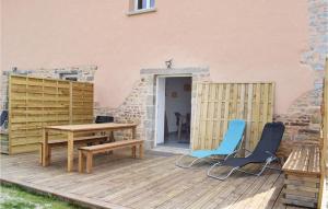 a wooden deck with two chairs and a table at Amazing Home In Sainteny With 2 Bedrooms And Wifi in Sainteny