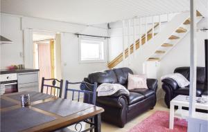 a living room with two leather chairs and a table at 2 Bedroom Gorgeous Home In Jämjö in JÃ¤mjÃ¶