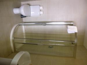 uma casa de banho com um WC e um dispensador de papel higiénico em The White Lady Hotel em Kinsale