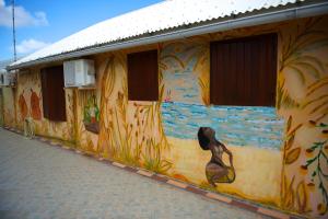 a building with a painting of a woman on the side at Holiday Home Soleil de Gwada in Sainte-Anne