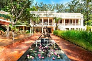 a house with a fountain in the middle of a courtyard at FCC Angkor by Avani in Siem Reap