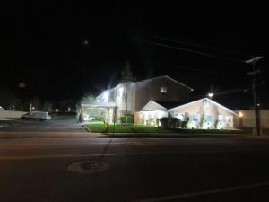 a house on a street at night with lights at West Valley Inn in West Valley City