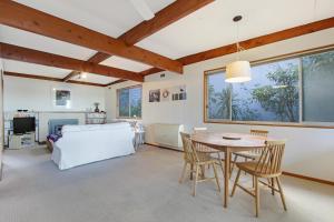 a living room with a table and chairs and a couch at Herons Rise in Metung