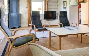 een woonkamer met stoelen en een tafel en een televisie bij Stunning Home In Vaggeryd With 2 Bedrooms And Sauna in Hok