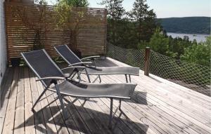 three chairs on a deck with a view of the water at Stunning Home In Nordre Frogn With Wifi in Båtstø