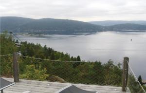 a view of a body of water with a fence at Stunning Home In Nordre Frogn With Wifi in Båtstø +10 photos