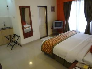 Postel nebo postele na pokoji v ubytování Nestor Hotel, Mumbai