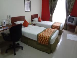 Postel nebo postele na pokoji v ubytování Nestor Hotel, Mumbai
