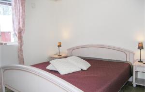 a bedroom with a bed with two pillows on it at 2 Bedroom Gorgeous Home In Bolms in Bolmsö