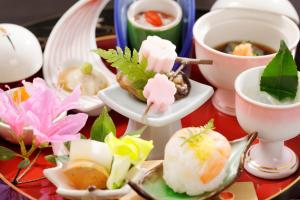 a table topped with dishes of food and a cup of tea at Hakone Fura in Hakone