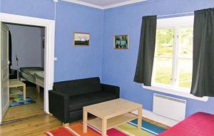 a living room with a couch and a chair at Holiday Home Braås Herrgård Braås in Braås