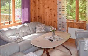 a living room with a couch and a table at 3 Bedroom Nice Home In Hallaryd in Hallaryd